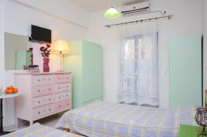 
a bedroom with a bed and a dresser at Galazia Studios in Naxos Chora

