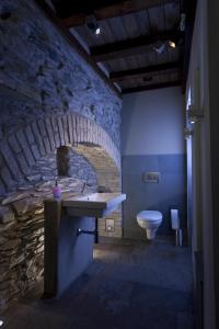 a stone bathroom with a sink and a toilet at Landgasthof Zum Weissen Schwanen in Braubach
