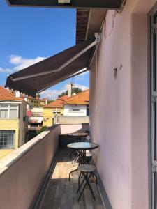 a balcony with a table and chairs on a building at Alojamento Mercado Sul in Lisbon
