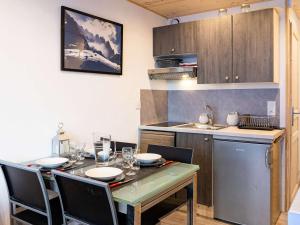 a kitchen with a table and chairs in a kitchen at Moderne appartement 4 pers à Val Thorens avec WiFi et balcon - FR-1-637-37 in Val Thorens +3 photos