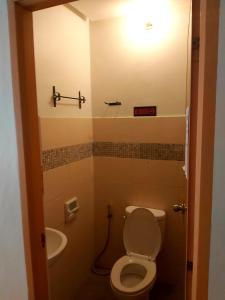 a bathroom with a toilet and a sink at OYO 916 Angel's Boardrooms in Manila