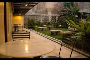 a table and chairs in a room with a garden at OYO 916 Angel's Boardrooms in Manila