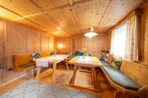 a room with wooden walls and tables and a window at Landhaus Valtelas in Sölden