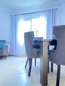 a dining room with a table and chairs at Armelle Sweet Home in Douala