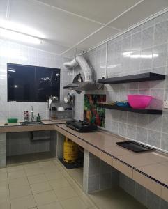 a kitchen with a counter and a counter top at E3 Summer Homestay 夏之屋 in Kudat