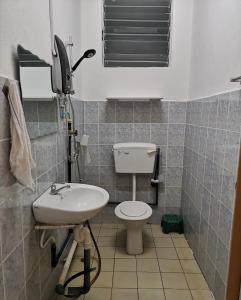 a small bathroom with a toilet and a sink at E3 Summer Homestay 夏之屋 in Kudat