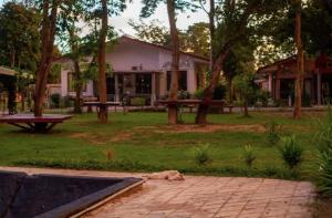 a dog laying on the grass in front of a house at Langkawi Rouhi Retreats By VP in Kuah +6 photos