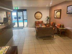 a living room with a couch and a table at Water Front Townsville in North Ward