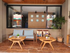 a living room with two tables and a couch at Dfeel House in Patong Beach