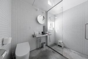 a bathroom with a toilet and a glass shower at 6ty6 - Vacation STAY 18030v in Niseko