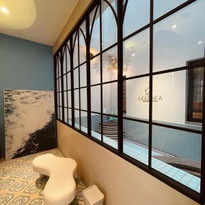 a white chair sitting in a room with a window at Akasaka Family Villa in Anping