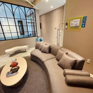 a living room with a couch and a table at Akasaka Family Villa in Anping