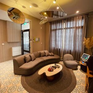 a living room with a couch and a coffee table at Akasaka Family Villa in Anping