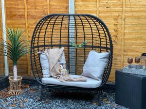 a swing chair with pillows and a book on it at Urban 3 Bedroom Home in Kings Heath-Great Location in Birmingham