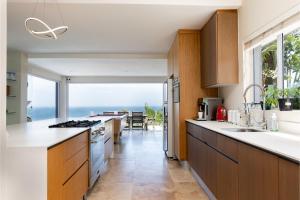 a kitchen with a view of the ocean at Madeleine Drive in Ballito