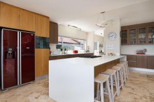 a kitchen with a white counter and a refrigerator at Madeleine Drive in Ballito