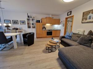 a living room with a couch and a table at Haus Seewind Wohnung 3 in Cuxhaven