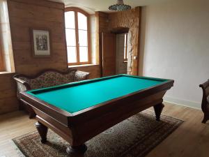 a room with a pool table in a room at Demeure pittoresque en pierres 1741 - 3 étoiles - 12 personnes in Arpenans