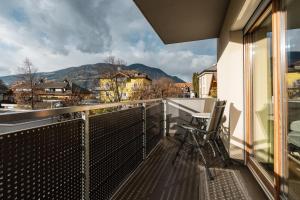 a balcony with a bike sitting on a railing with a view at FaWa Apartments "Villa Mai" in Brunico