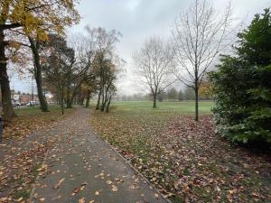 a path in a park with leaves on the ground at Urban 3 Bedroom Home in Kings Heath-Great Location in Birmingham +12 photos