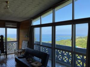 a living room with a view of the ocean at GantanBunny in Motobu