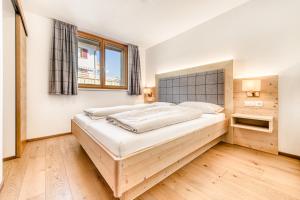 Ένα ή περισσότερα κρεβάτια σε δωμάτιο στο Appartements im Kirchberg by A-Appartments