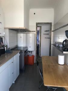 a kitchen with a wooden table in a room at Alojamento Mercado Sul in Lisbon +12 photos