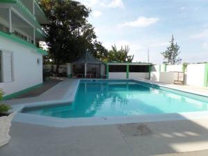 a large blue swimming pool next to a building at Villa Donna Inn in Montego Bay