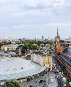 a view of a city with a building and a clock tower at Platform 9 3/4 by condokeeper in London