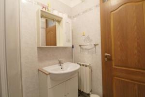 a bathroom with a sink and a toilet and a mirror at Apartments LEO with pool in Umag +87 photos