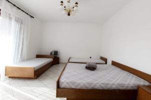 a bedroom with two beds and a chandelier at Apartments LEO with pool in Umag
