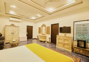 a room with a bed and a flat screen tv at Bloom Boutique l A Heritage Property at Lake Pichola in Udaipur