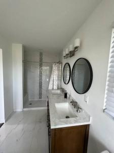a white bathroom with a sink and a mirror at Modern Home at Colonial College Park Atlanta in Atlanta
