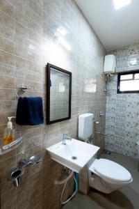 a bathroom with a toilet and a sink at Lotus 3BHK by SoulStays in Dapoli