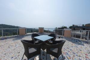 a table and chairs sitting on top of a roof at Lotus 3BHK by SoulStays in Dapoli