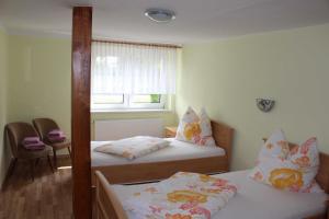 a room with two beds and a window at Ferienhaus _Erika_ Familie Meier in Boldekow