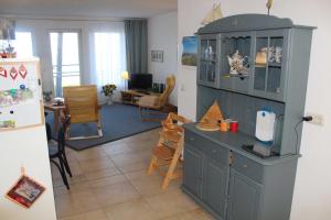 una cucina con armadio blu e un soggiorno di Ferienwohnung Schwanenwiek a Lubmin