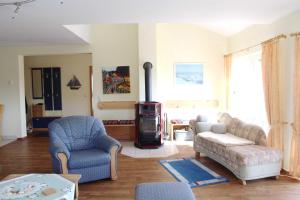 a living room with a couch and a wood stove at Ferienwohnung am Schloss in Ueckermünde