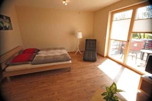 a bedroom with a bed and a large window at Ferienappartements Jack _ Richies in Greifswald