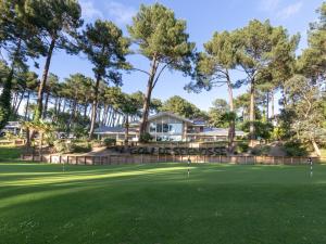 a golf course with trees in the background at Maison Seignosse, 2 pièces, 4 personnes - FR-1-239-421 in Seignosse