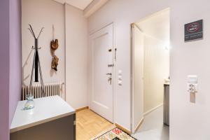 a room with a white door and a white table at Bang in Kolonaki by Athenian Homes in Athens