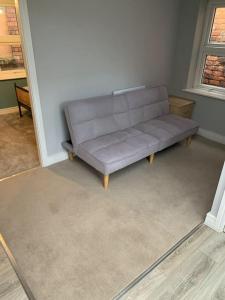 a gray couch sitting in a living room at Town Centre Getaway in Southport