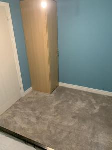 a room with a door and a room with carpet at Town Centre Getaway in Southport