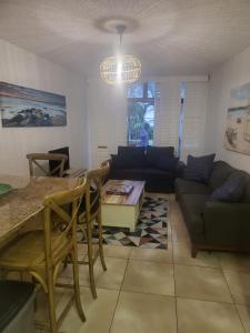 a living room with a couch and a table at Umhlanga Breakers Resort in Durban +14 photos