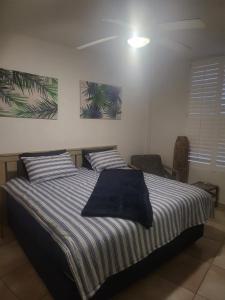 a bedroom with a bed with blue and white striped sheets at Umhlanga Breakers Resort in Durban