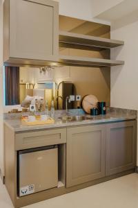 a kitchen with a sink and a counter at Yoonah at Benson Pakuwon Mall in Lontar