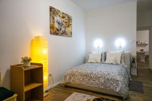 a bedroom with a bed and a yellow lamp at Cosy Casa in Budapest