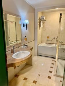 a bathroom with a sink and a bath tub at Relais La Fattoria in Melfi