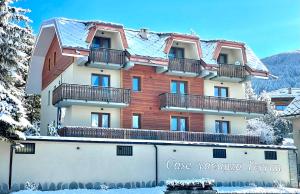 a large building with balconies on top of it at Case Vacanza Perron in Sauze dʼOulx