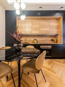 a dining room with a black table and chairs at ELITE SUITE by EdSam, In Madrid in Madrid